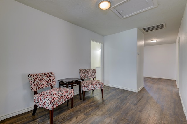 living area with dark wood-type flooring and a textured ceiling