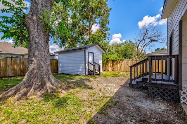 view of yard with a storage shed and a deck