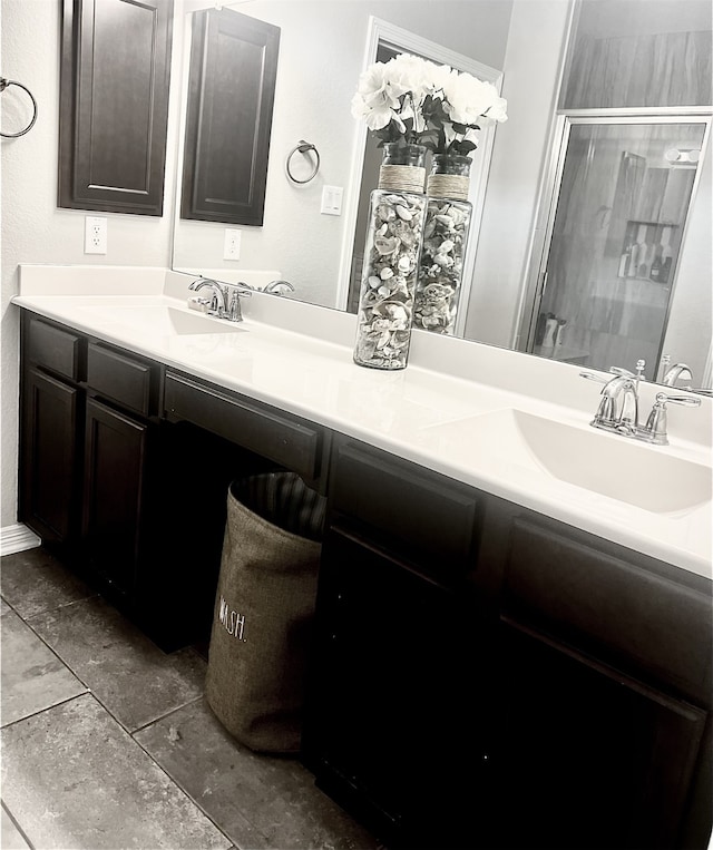 bathroom featuring a shower with door and vanity