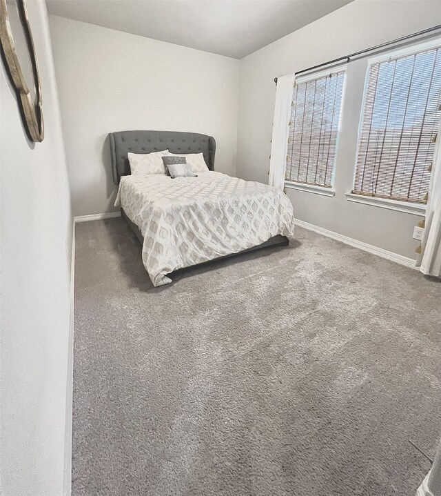 bedroom featuring dark colored carpet