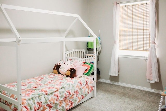 carpeted bedroom featuring multiple windows