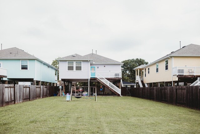 rear view of property featuring a lawn