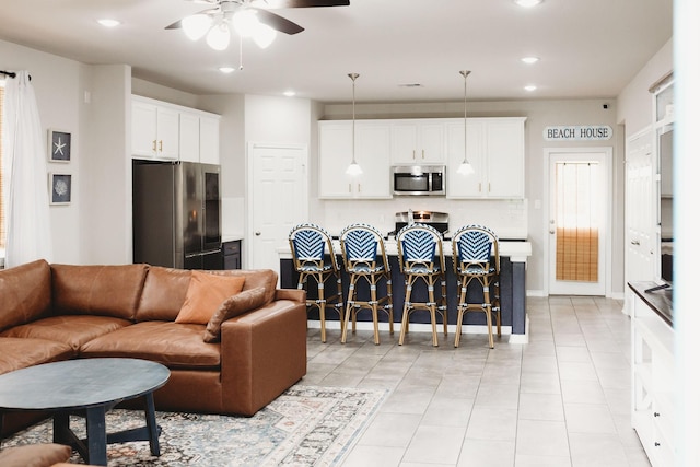 tiled living room featuring ceiling fan