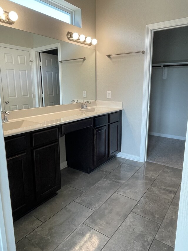 bathroom featuring tile patterned flooring and vanity