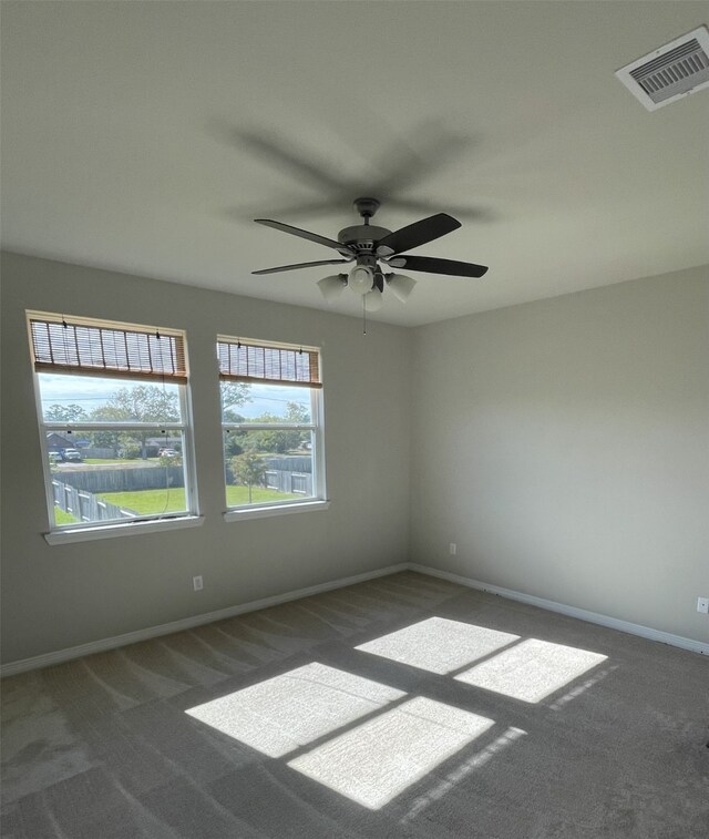 carpeted empty room featuring ceiling fan