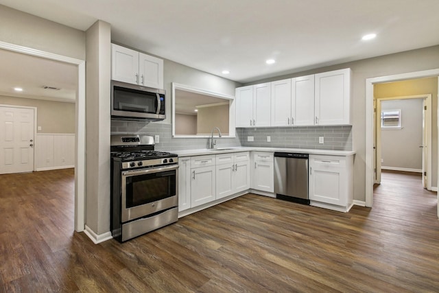 kitchen featuring white cabinets, dark hardwood / wood-style flooring, and appliances with stainless steel finishes