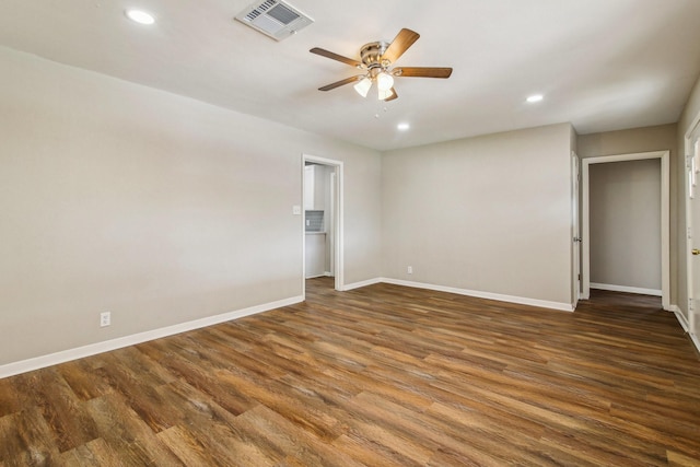 spare room with dark hardwood / wood-style floors and ceiling fan