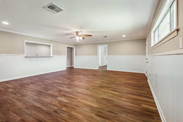 unfurnished living room featuring crown molding, ceiling fan, and dark wood-type flooring