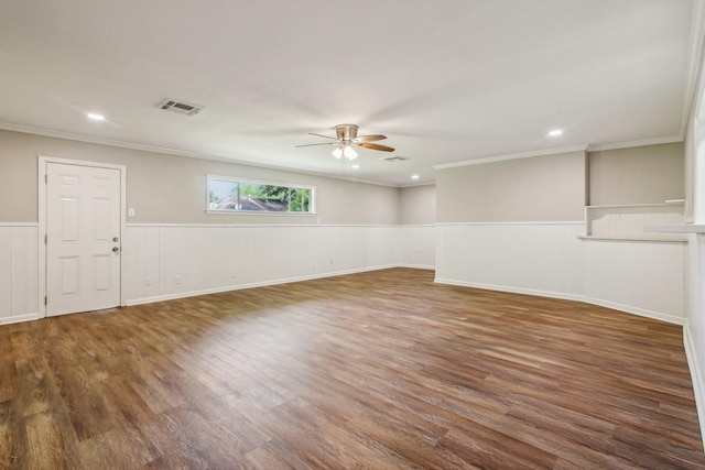 empty room with ceiling fan, ornamental molding, and dark wood-type flooring