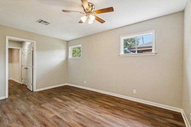 empty room featuring dark hardwood / wood-style floors and ceiling fan