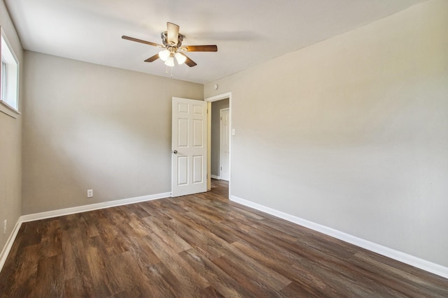 empty room featuring dark hardwood / wood-style floors and ceiling fan