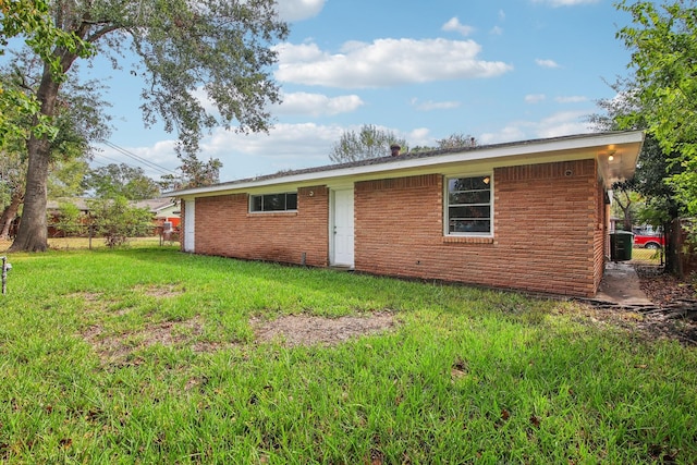 rear view of house with a yard