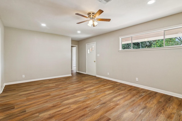 unfurnished room with hardwood / wood-style flooring and ceiling fan