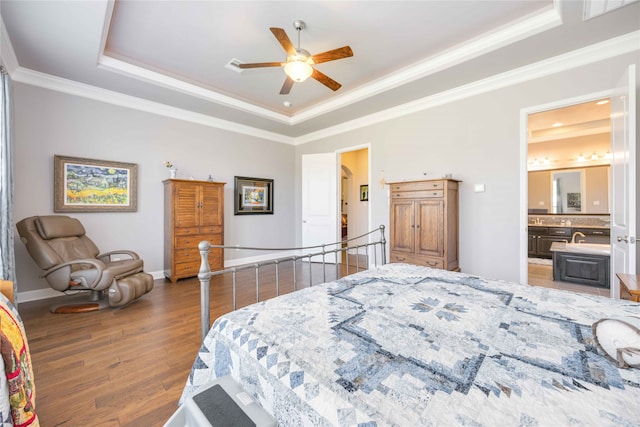 bedroom with dark wood-type flooring, ceiling fan, crown molding, and a tray ceiling