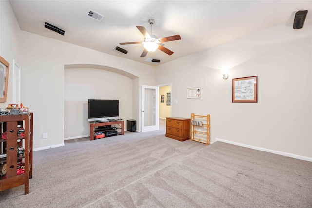 living room featuring light carpet and ceiling fan