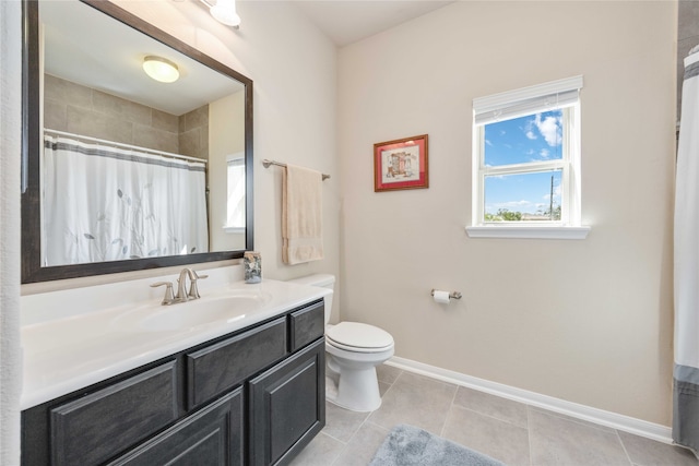 bathroom with toilet, vanity, tile patterned floors, and walk in shower