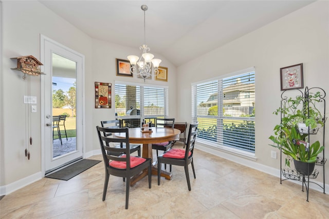 dining space featuring an inviting chandelier and vaulted ceiling