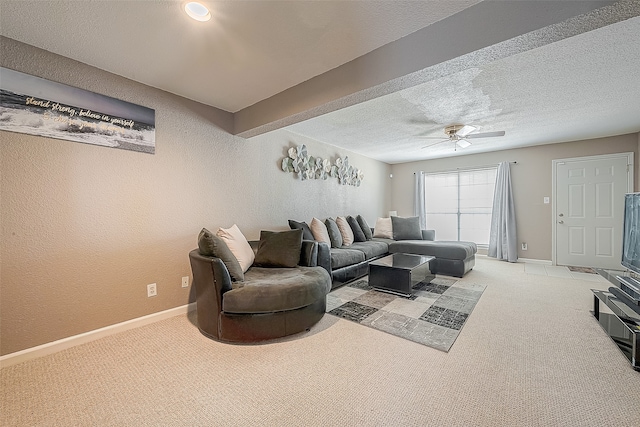 carpeted living room with beamed ceiling, a textured ceiling, and ceiling fan