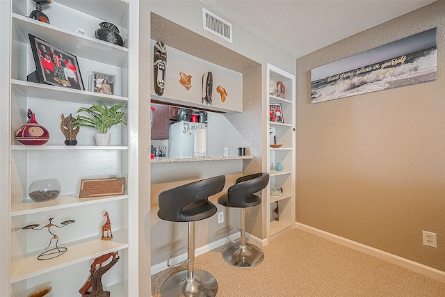 bar with a textured ceiling, carpet flooring, and white refrigerator