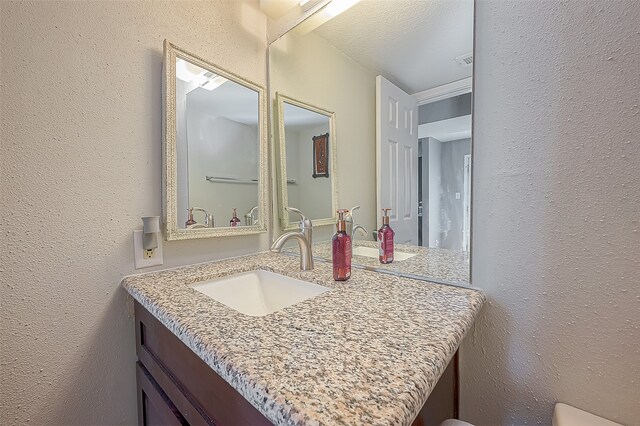 bathroom with vanity and a textured ceiling