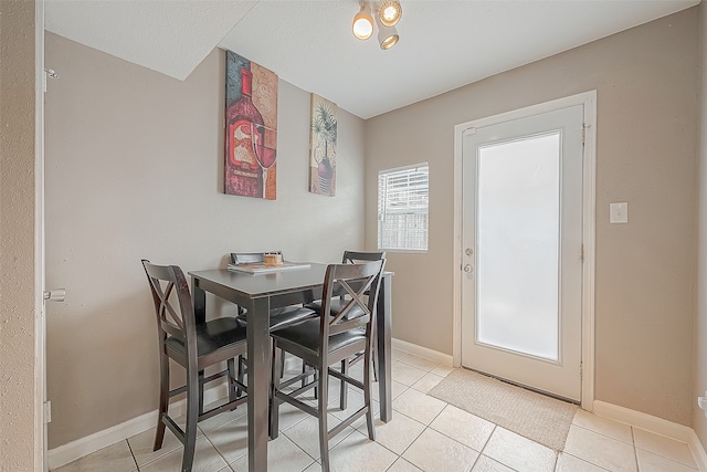 tiled dining room with a textured ceiling