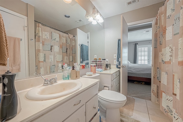 bathroom with ceiling fan, tile patterned flooring, vanity, and toilet