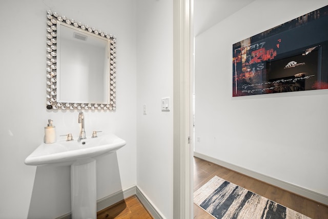 bathroom with hardwood / wood-style floors