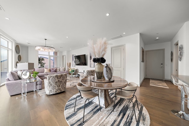 dining room with wood-type flooring and a chandelier