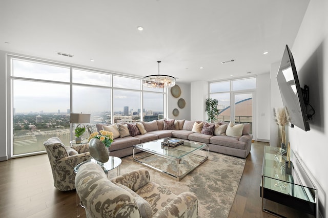 living room with a wall of windows, a notable chandelier, and dark hardwood / wood-style floors