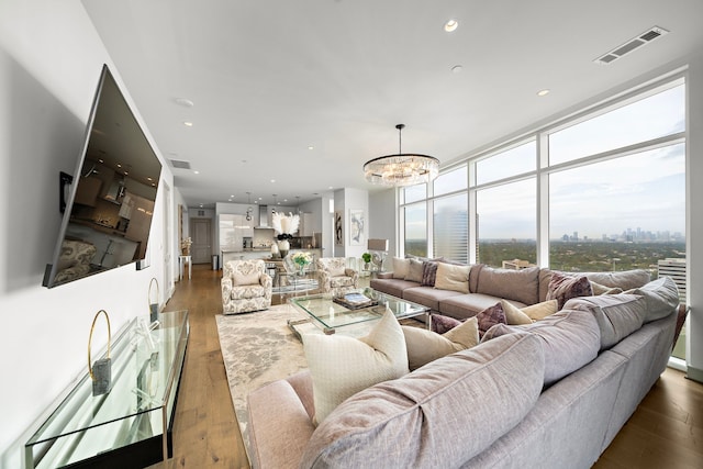 living room featuring expansive windows, a chandelier, and dark hardwood / wood-style flooring