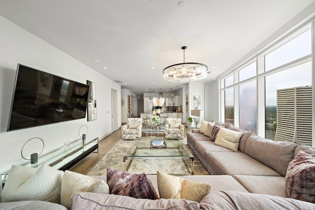 living room with hardwood / wood-style floors and a chandelier