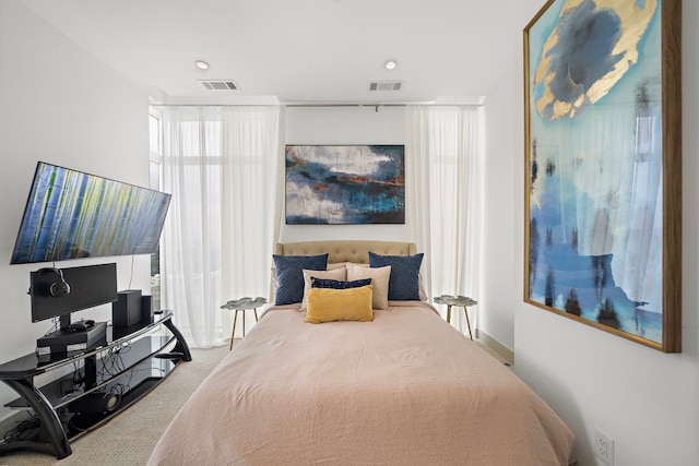 carpeted bedroom with multiple windows