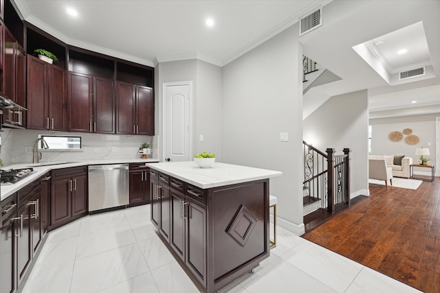 kitchen featuring light wood-type flooring, a center island, stainless steel dishwasher, and crown molding