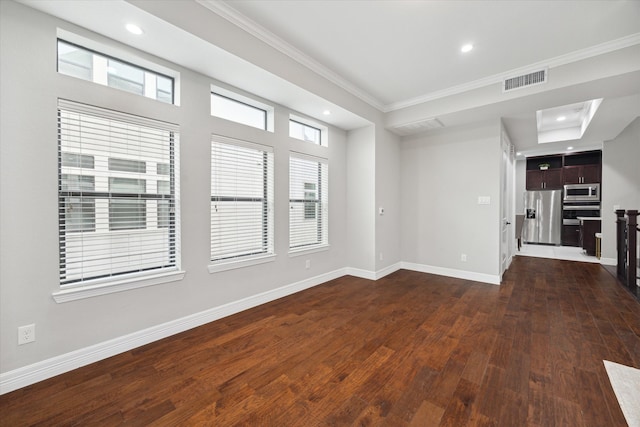 unfurnished living room with a healthy amount of sunlight, dark hardwood / wood-style flooring, and ornamental molding