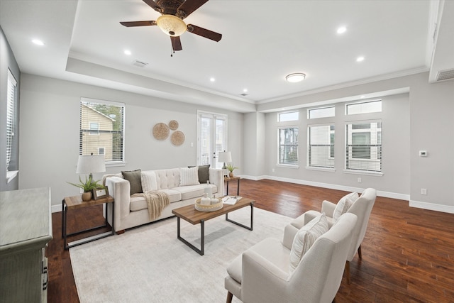 living room featuring dark hardwood / wood-style floors, ceiling fan, and ornamental molding