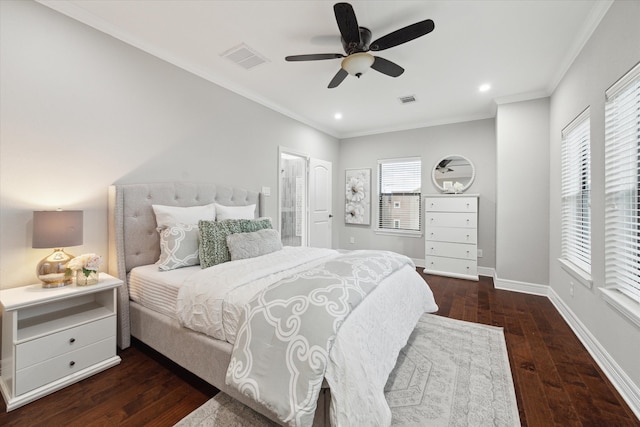 bedroom with dark hardwood / wood-style floors, ceiling fan, and ornamental molding