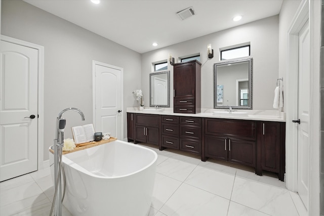 bathroom with a bathing tub and vanity