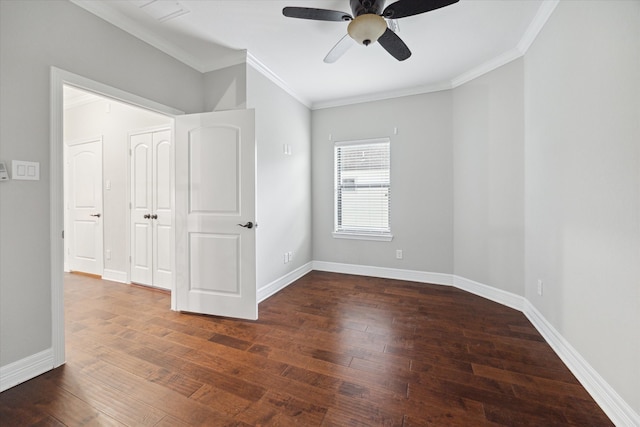 spare room featuring crown molding, ceiling fan, and dark wood-type flooring