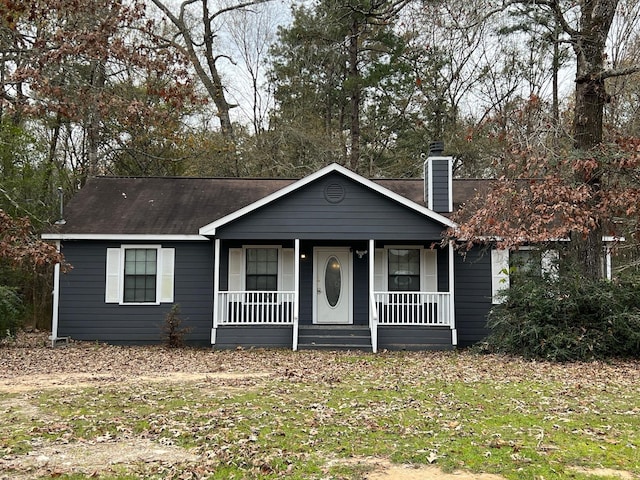 view of front of home with covered porch and a front yard