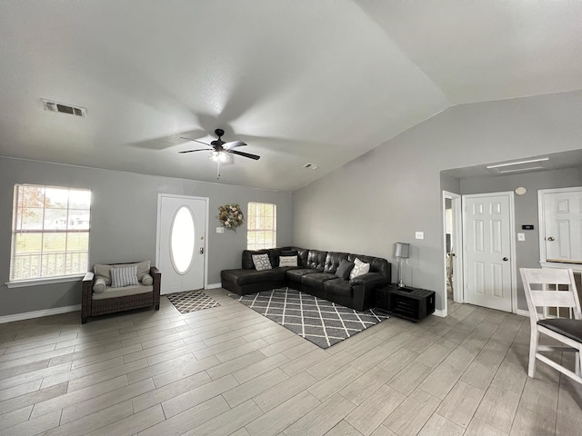 living room with ceiling fan, light hardwood / wood-style flooring, and lofted ceiling