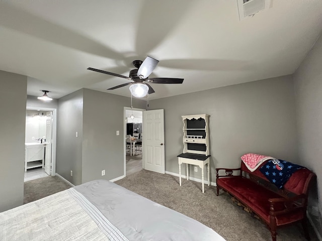 bedroom featuring carpet, ensuite bathroom, and ceiling fan