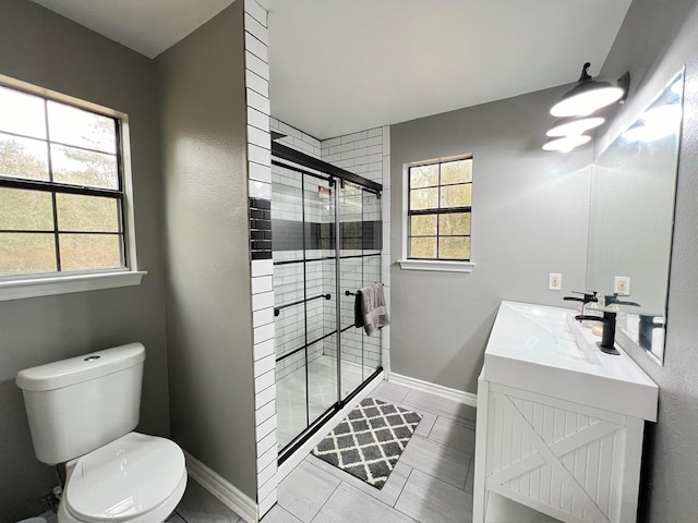 bathroom with tile patterned flooring, vanity, toilet, and a shower with shower door