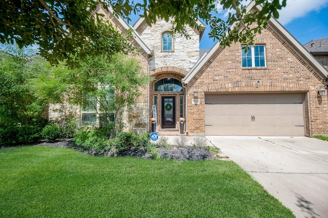 view of front of house with a garage and a front lawn