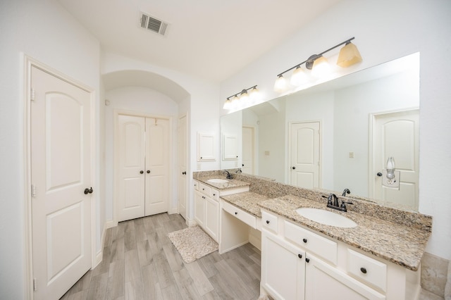 bathroom featuring vanity and hardwood / wood-style floors