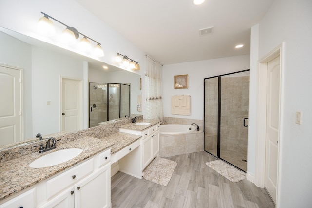 bathroom with vanity, plus walk in shower, and hardwood / wood-style flooring