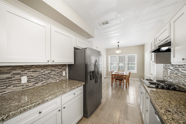 kitchen featuring decorative backsplash, white cabinetry, stone counters, and stovetop