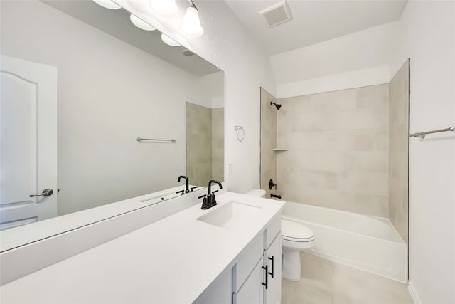 full bathroom featuring tile patterned floors, vanity, tiled shower / bath combo, and toilet