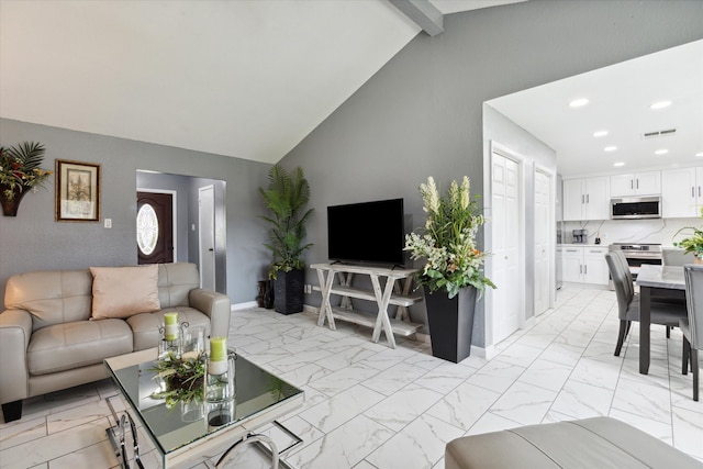 living room with high vaulted ceiling and beamed ceiling