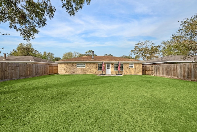 back of property with a lawn