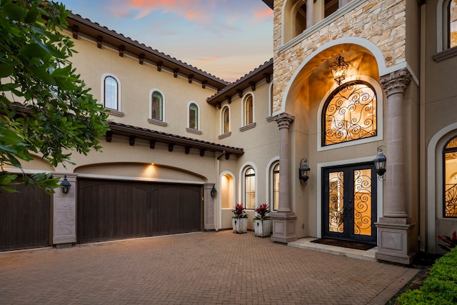 view of front of home with french doors and a garage